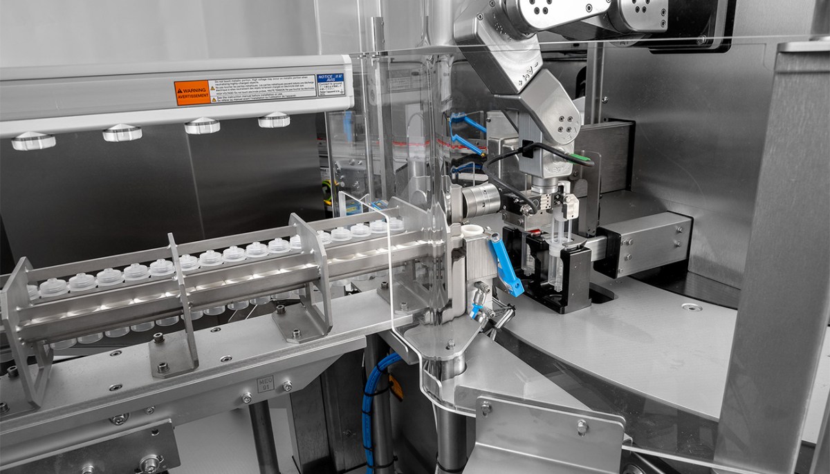 Mecademic Meca500 robot arm performing precision packing and assembly in an automated system.