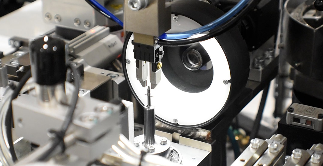 Microscopic view of an automated assembly process, illustrating the efficiency and precision of Mecademic's robotics in micro-assembly applications.