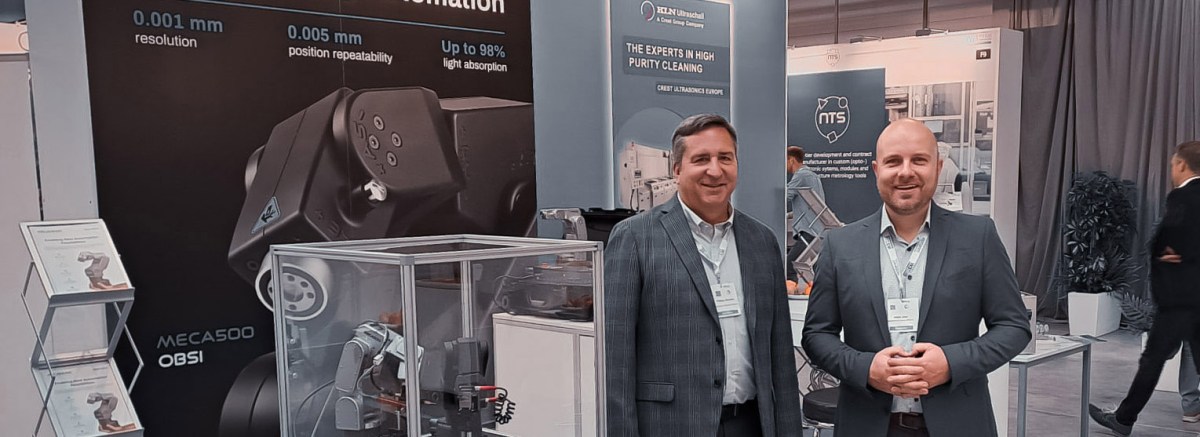 Stefan John and Philippe Beaulieu at the Mecademic stand during the W3+ Fair Jena 2024, showcasing the Meca500 robot.